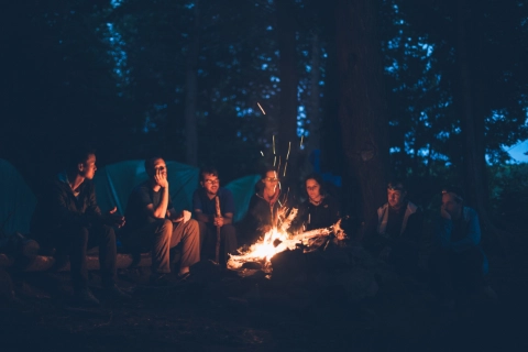 A group of people gathered around a campfire.